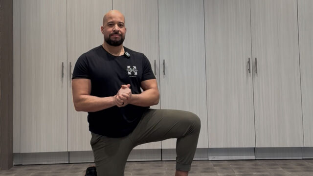Coach Greg demonstrates the cross body stretch