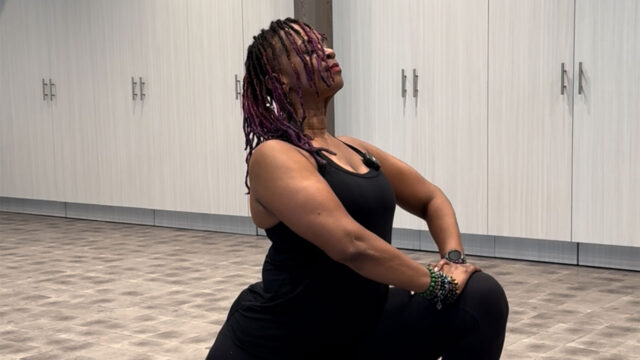 Instructor Lateefah stretching