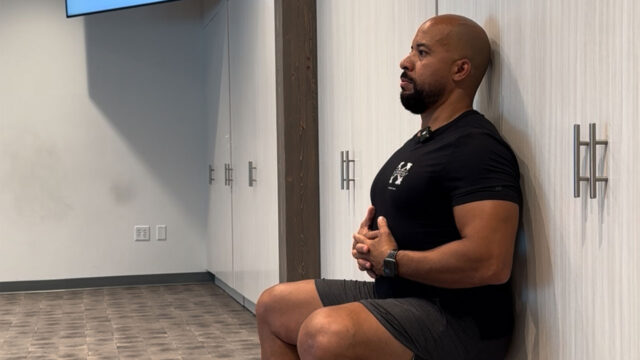 Coach Greg demonstrates the wall-sit