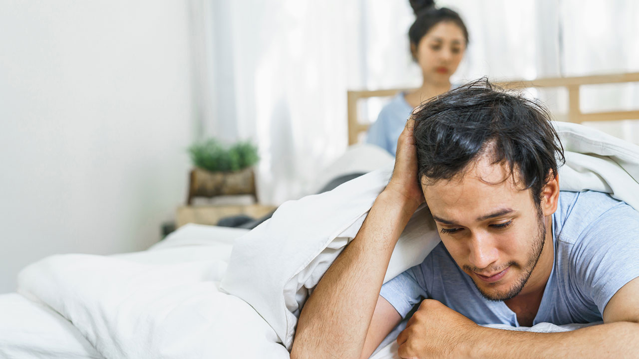 Unhappy couple in bed