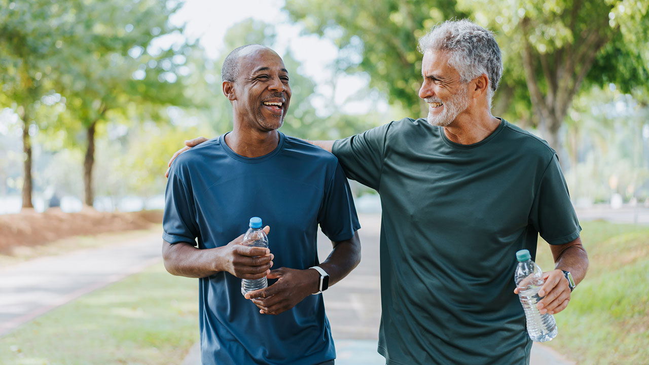 Senior men friends walking in public park