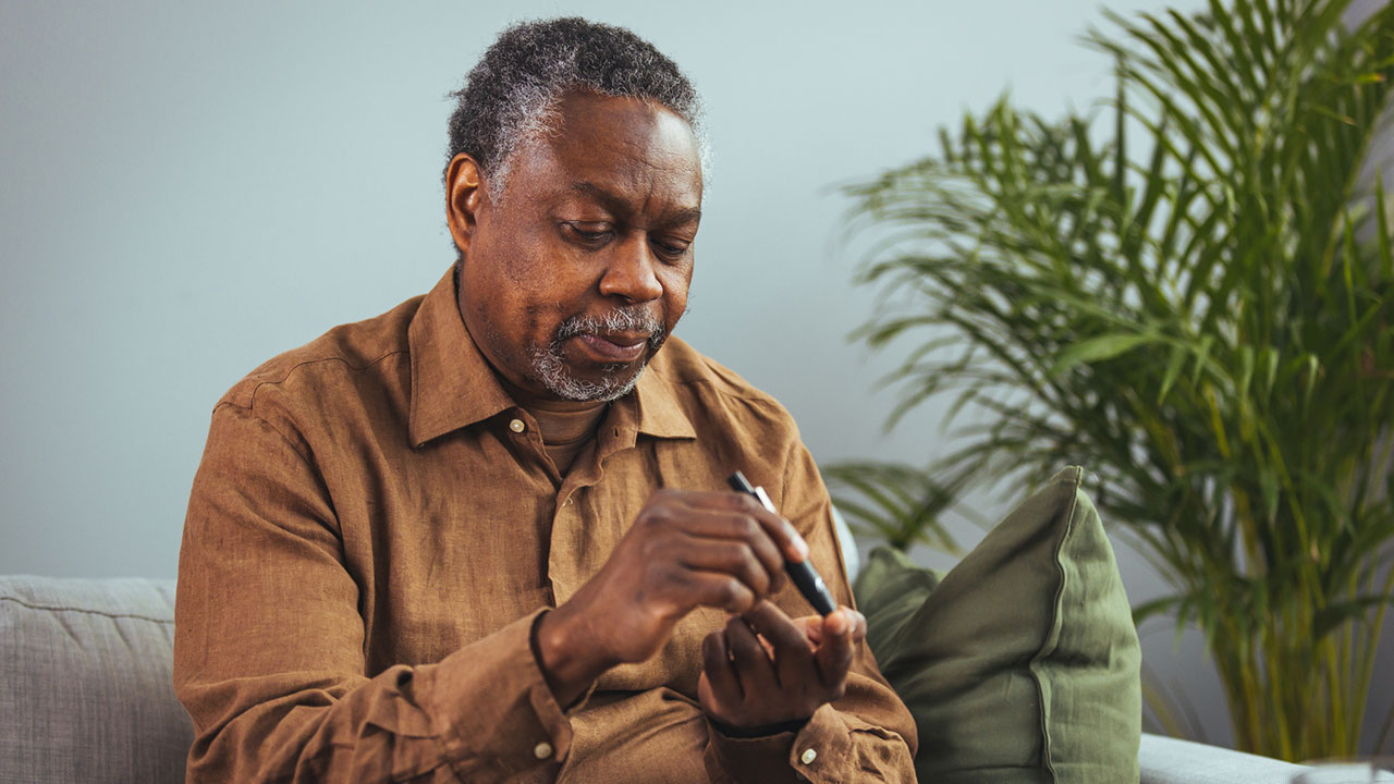 Diabetic man testing his blood sugar